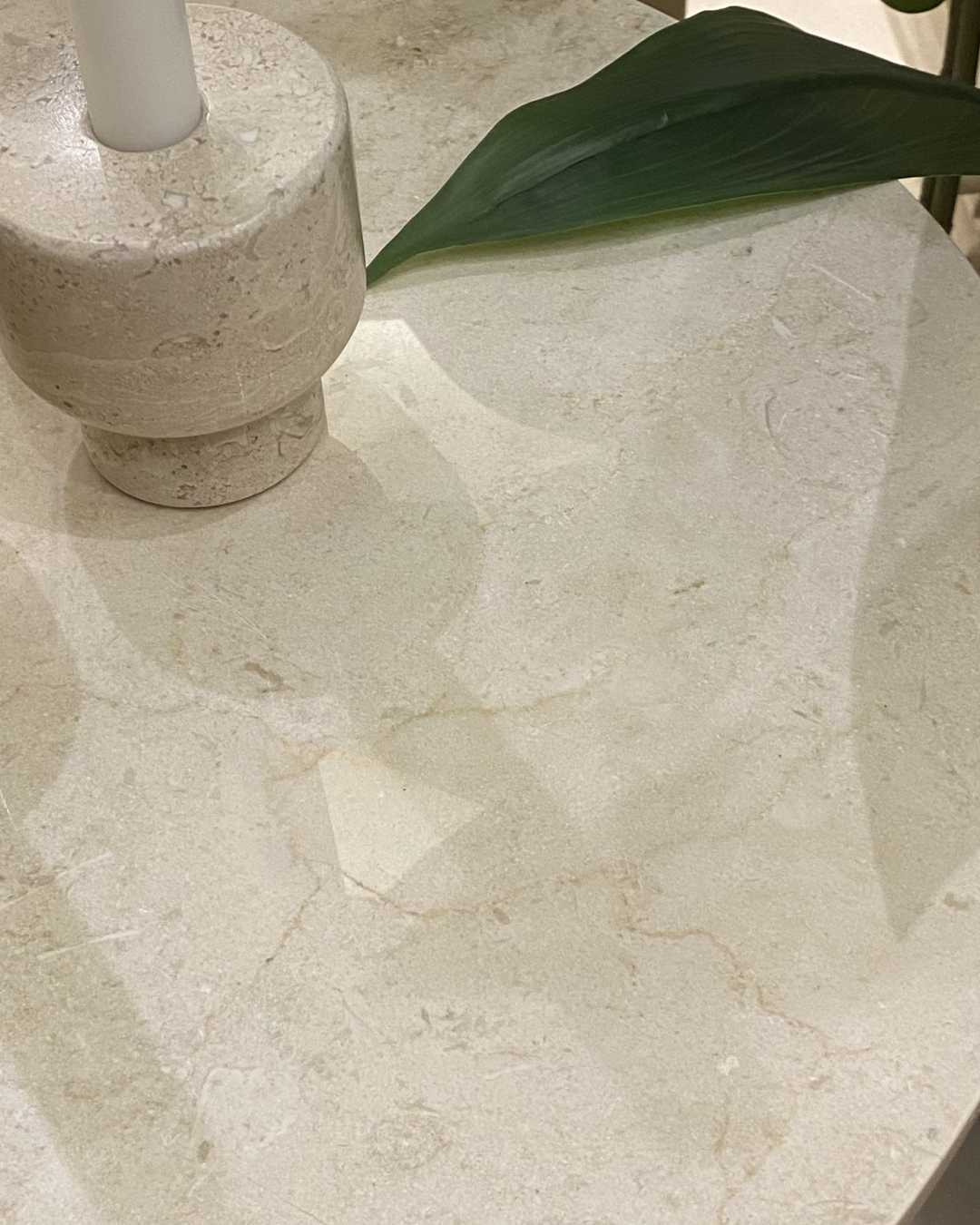 Close-up view showing smooth Crema Marfil veining and soft edge