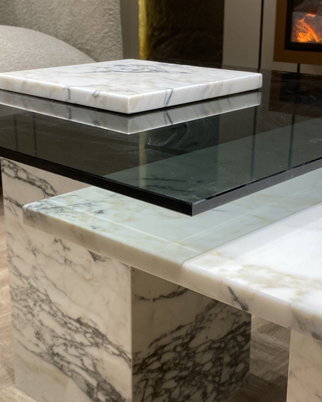 Close-up of tinted glass top on Greta Coffee Table, highlighting fixed marble insert and edge clarity
