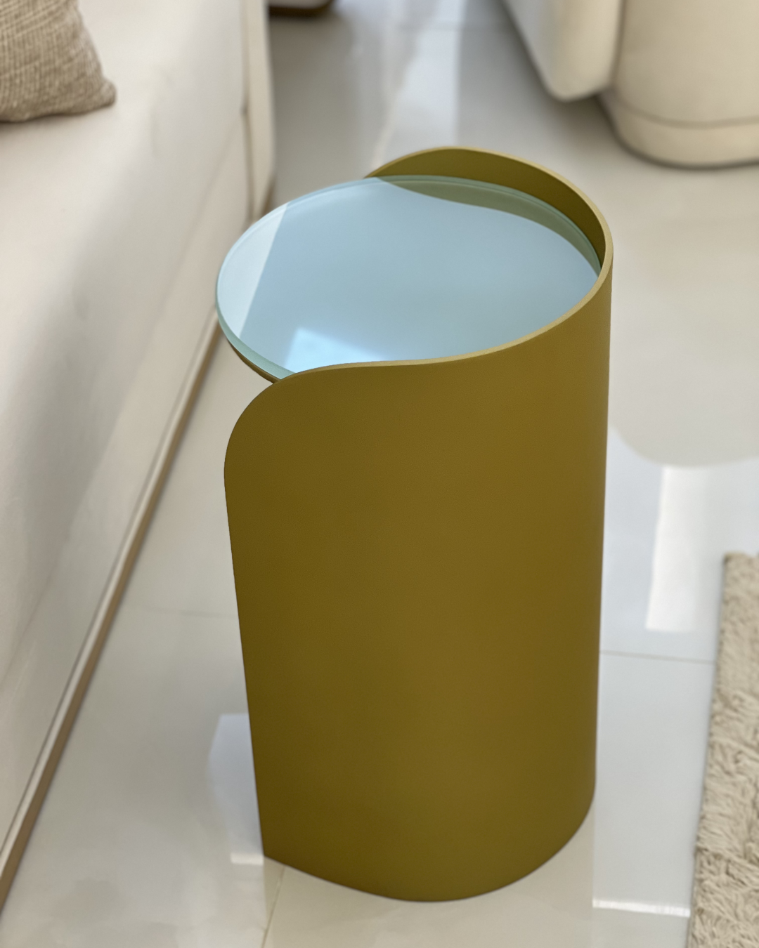 Lucente serving table placed next to a neutral-toned sofa for scale