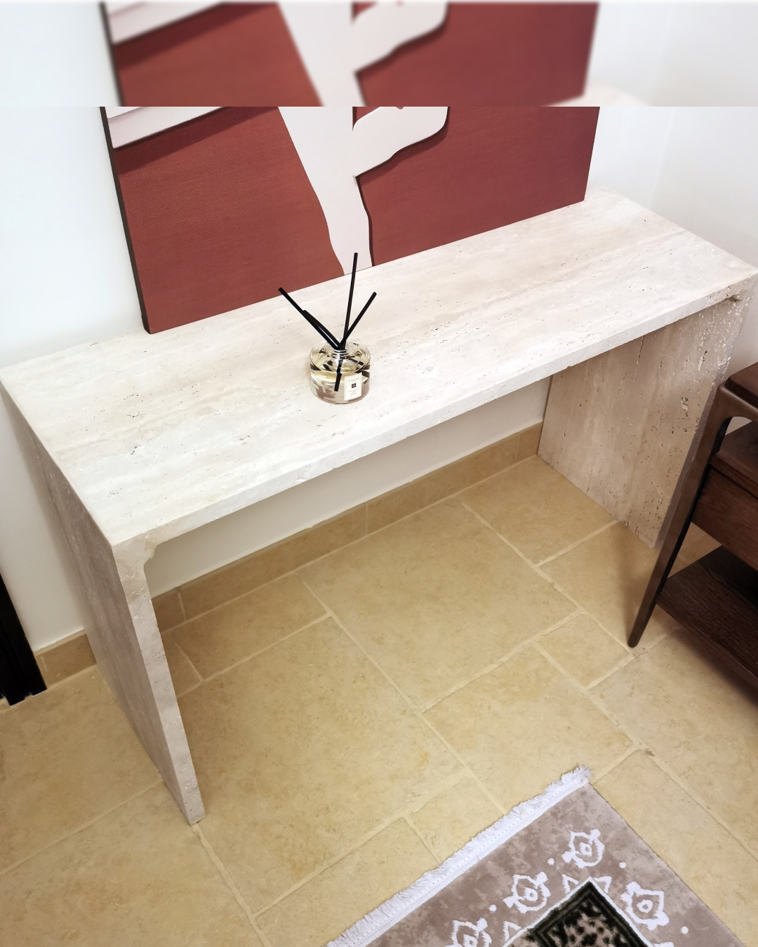 Frontal view of Mira Console Table showcasing natural travertine texture