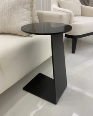 Nero Serving Table placed beside modern sofa