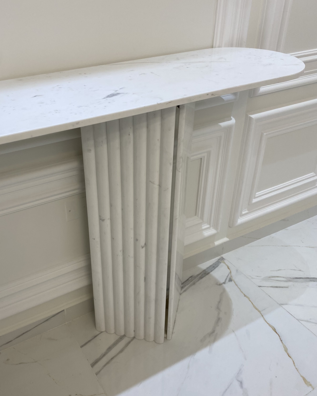 Detail of fluted and flat marble base panels