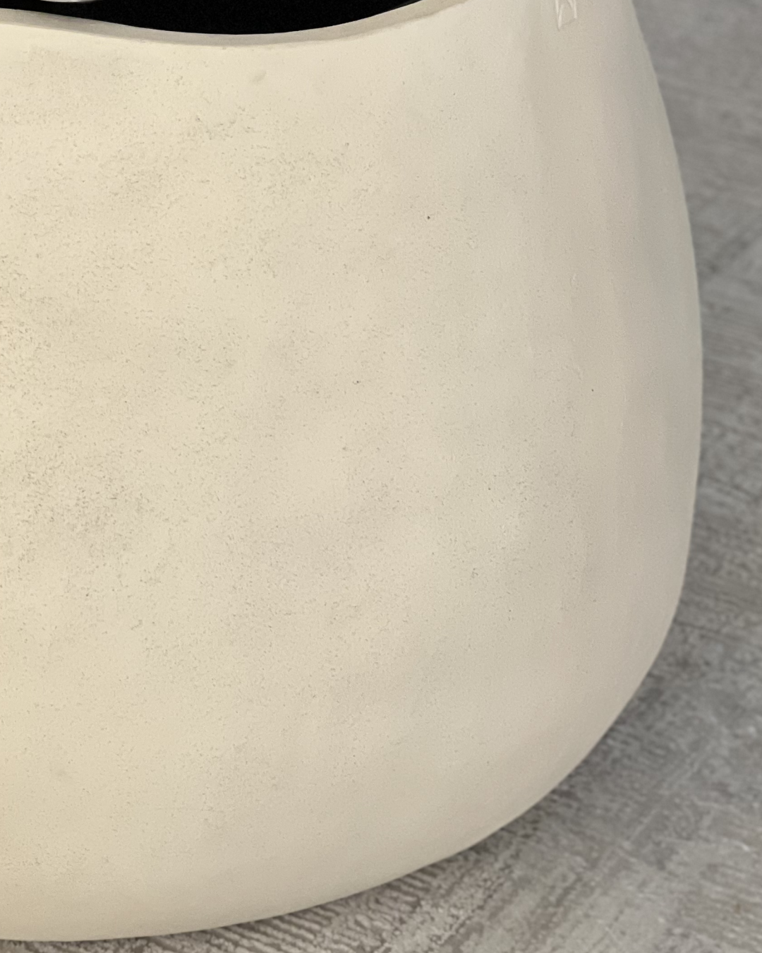 Close-up of the off-white textured planter surface