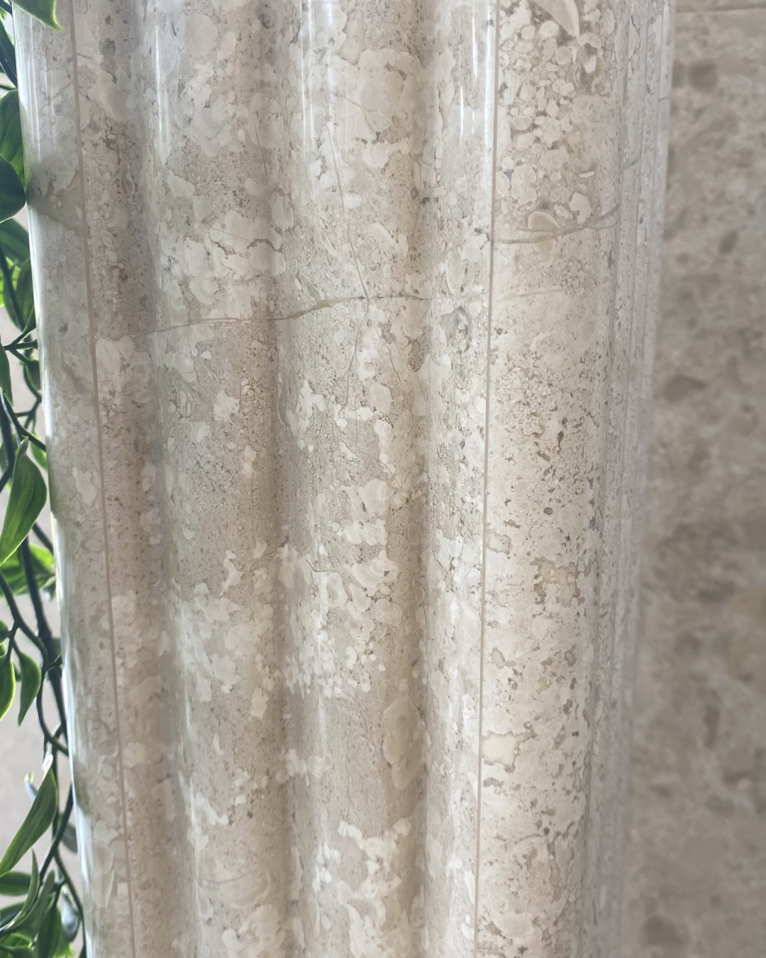 Detail showing light interaction on fluted stone surface