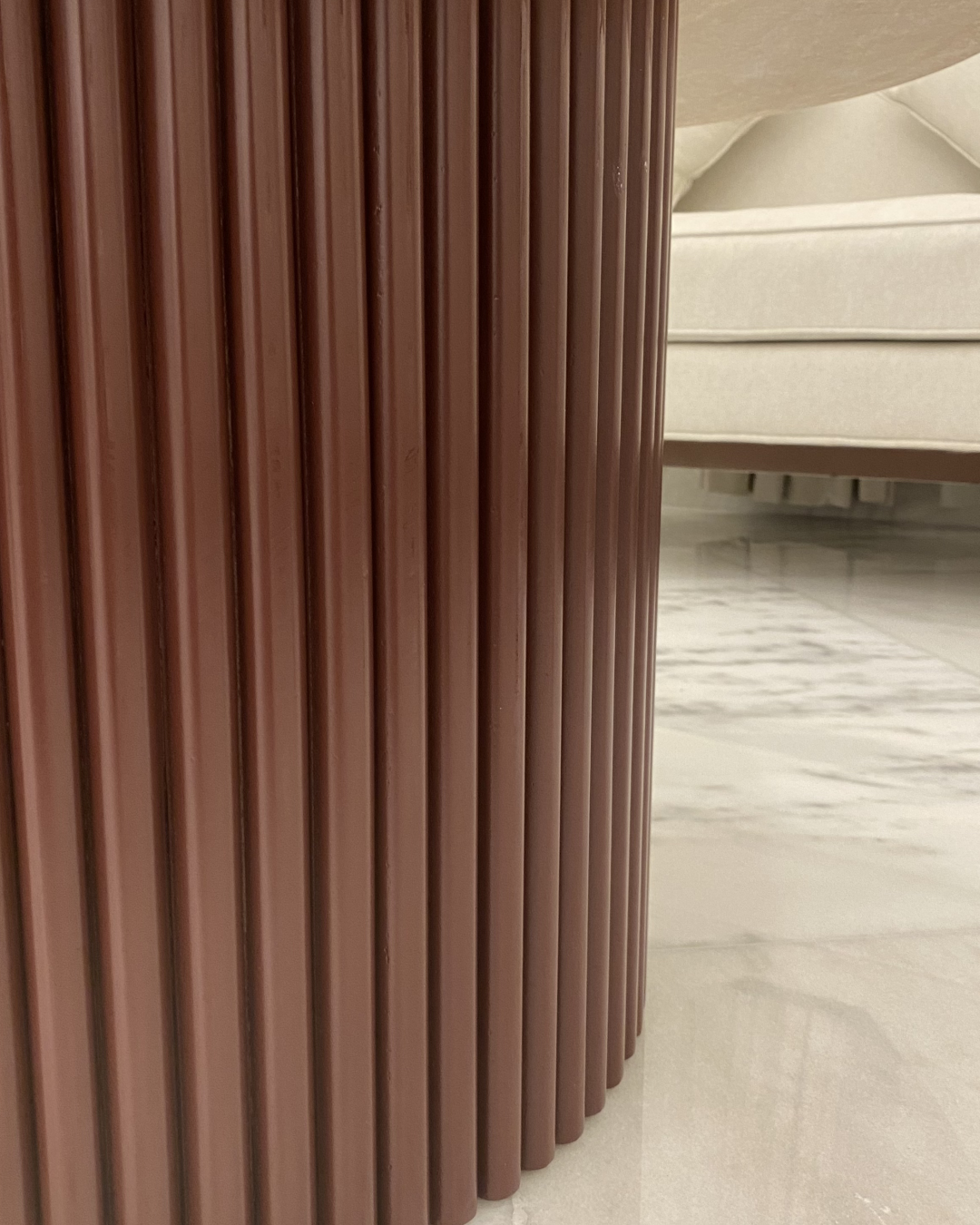 Close-up of fluted chocolate brown wooden base