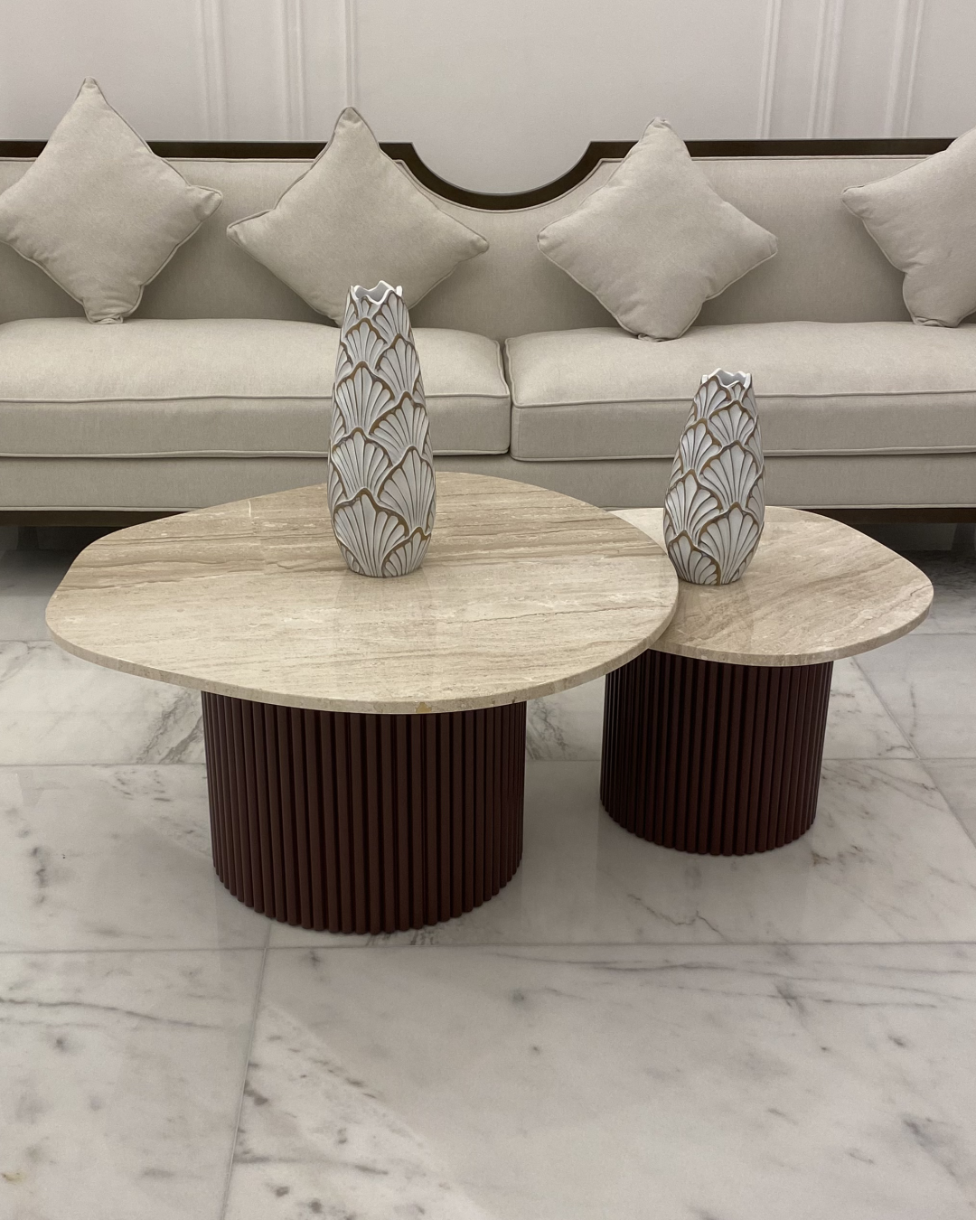 Raqia Coffee Table set featuring two marble-topped tables with fluted brown bases