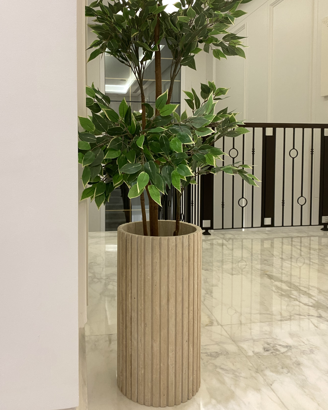 Ravino Planter styled in a marble hallway setting