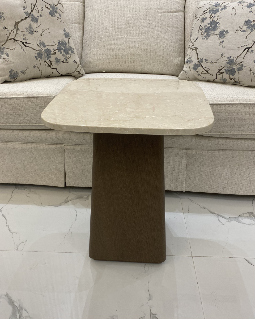 Front view showing square marble top and tapered veneer base
