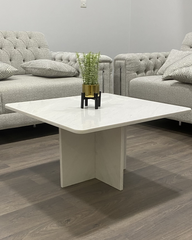 Frontal angle of Tara Coffee Table showing cross-base and polished Polaris marble top