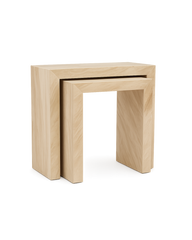 A pair of nested rectangular console tables made from Royal Dino marble with angled veining and seamless block-style construction, showcasing a minimalist stacked design.