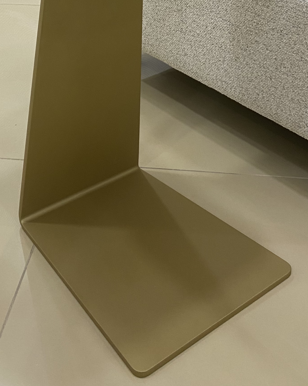 Close-up view of the gold-painted aluminum base highlighting the italicized C shape and craftsmanship