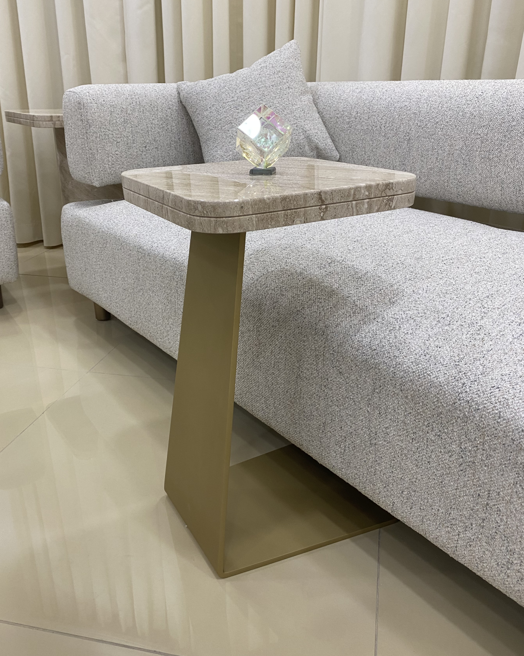 Zina Serving Table styled in a lounge beside seating