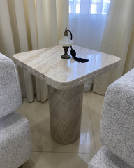 Angled view showing marble veining and handcrafted base