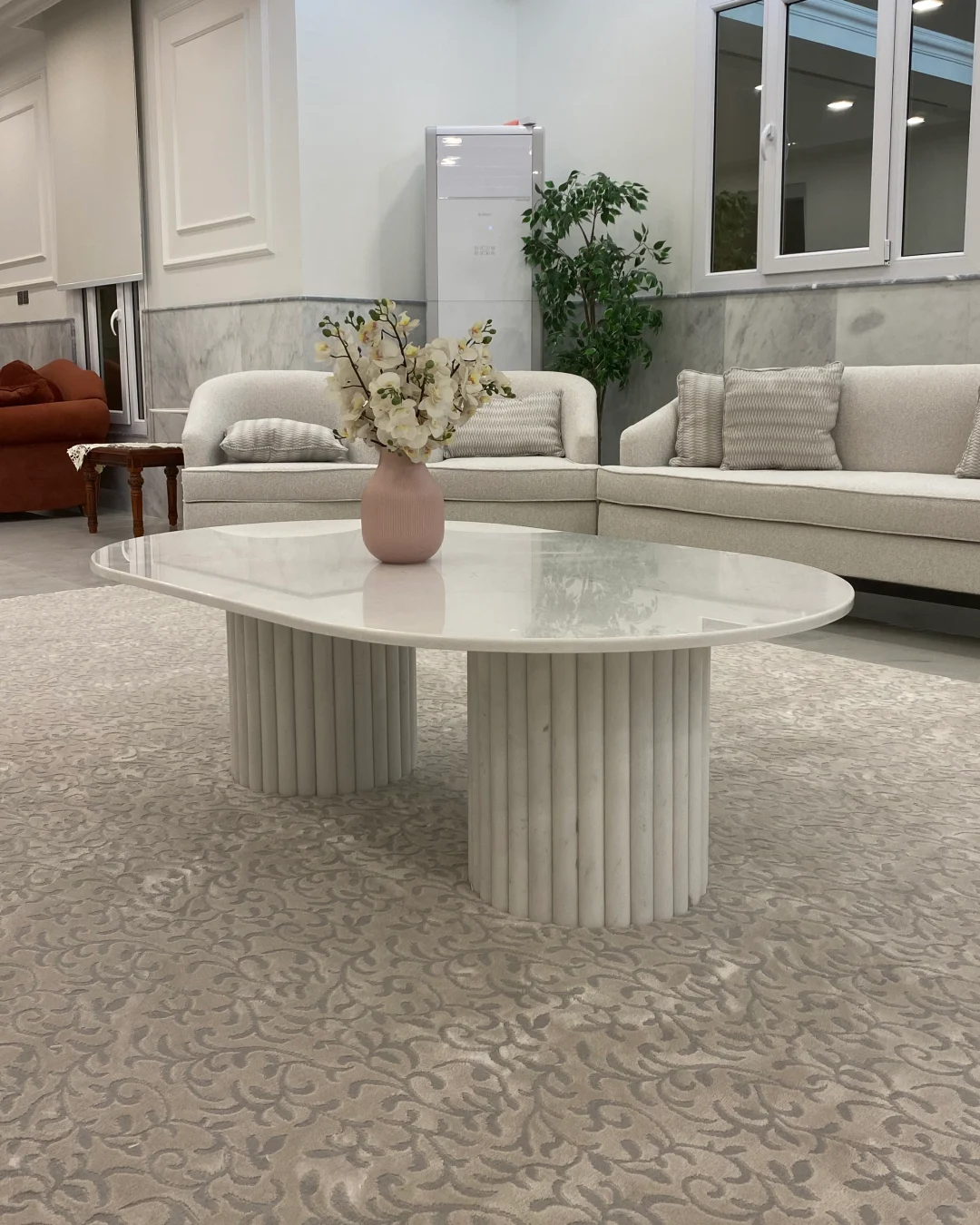 Full view of Nova Coffee Table showing capsule marble top and fluted bases