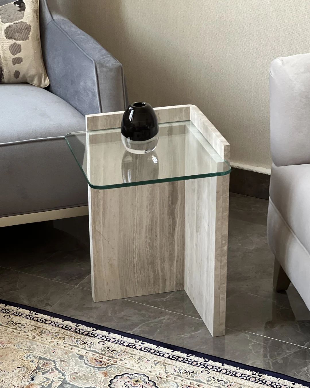 Full view of Safa Side Table with clear glass top and intersecting White Wood Marble base