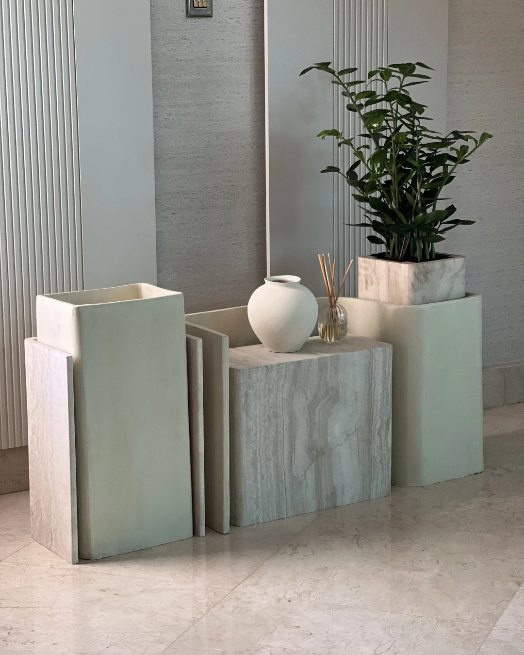 Side view focusing on left travertine shell and wooden planter