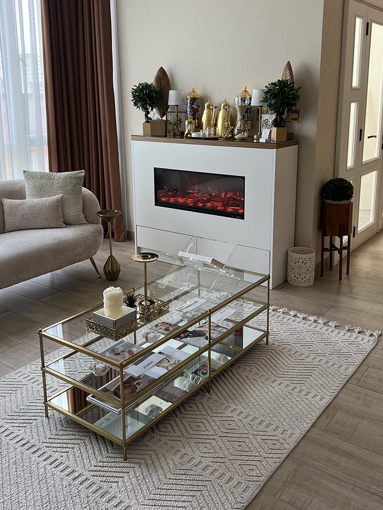 Binan Skin Care Center waiting area with custom console, artificial fireplace feature, storage, and styled decor